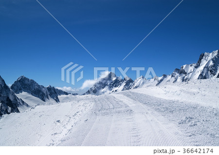 Snowy road with trace from snow groomer  36642174