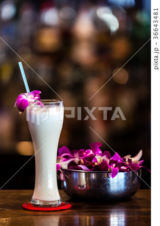 White cocktail with orchid flower in the bar White cocktail with orchid flower in the bar 36643481