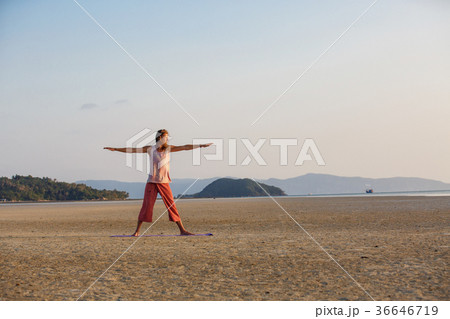 Man is doing yoga on the beach Man is doing yoga on the beach 36646719