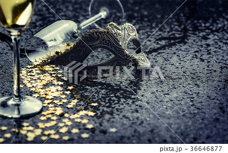 carnival mask and star-shaped confetti with glass 36646877