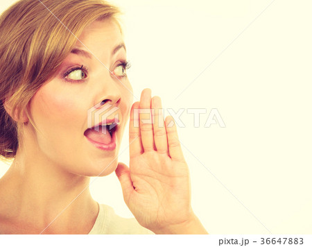 Woman whispering with hand close to mouth 36647883