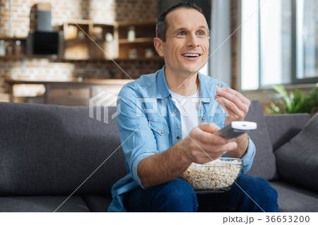 Attractive man looking forward while eating Attractive man looking forward while eating 36653200