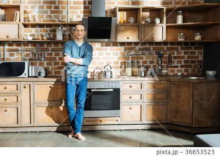 Confident man standing in the kitchen 36653523