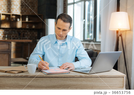 Serious male person making notes 36653756