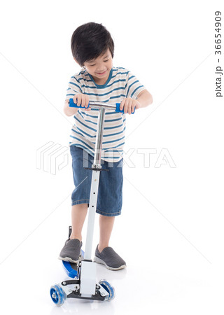 Asian boy riding a scooter on white background Asian boy riding a scooter on white background 36654909