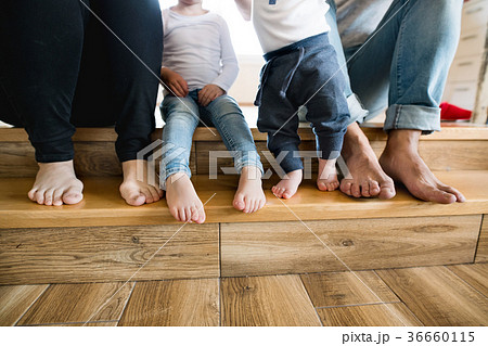 Beautiful young family. Bare feet of mother Beautiful young family. Bare feet of mother 36660115