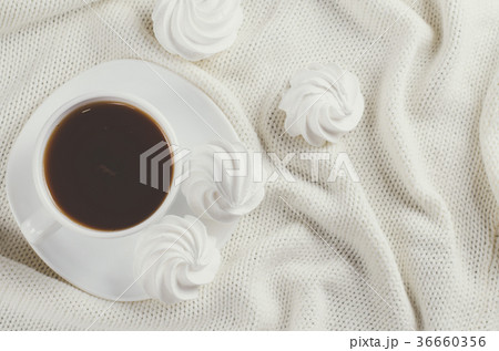 Delicious meringue cookies and cup of hot tea. Delicious meringue cookies and cup of hot tea. 36660356