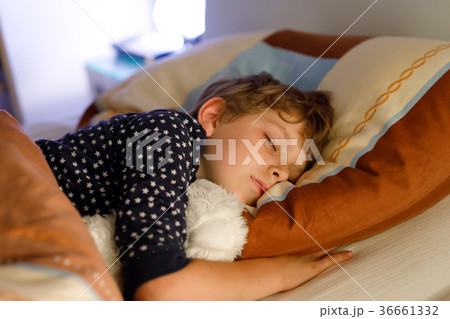 Little preschool kid boy sleeping in bed with 36661332