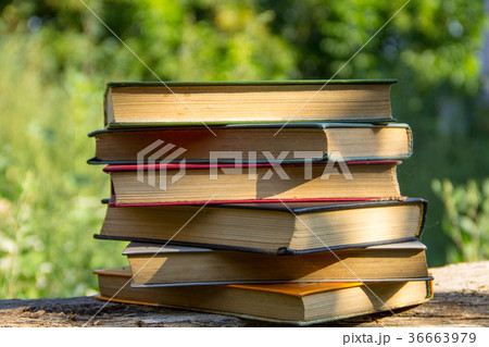 Stack of the old books on wooden table outdoor Stack of the old books on wooden table outdoor 36663979