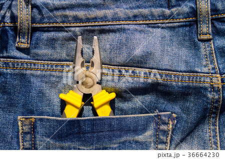 Pliers to repair in pocket of blue jeans 36664230