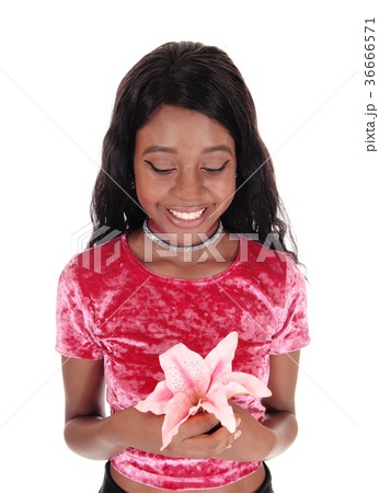 African woman holding pink lily 36666571