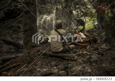 Young traveler looking on the waterfall at 36669223