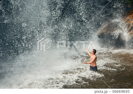 Man in waterfall Man in waterfall 36669695