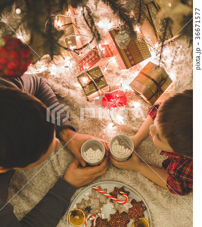 Father and son laying under christmas tree. Father and son laying under christmas tree. 36671577
