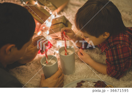 Father and son laying under christmas tree. Father and son laying under christmas tree. 36671595