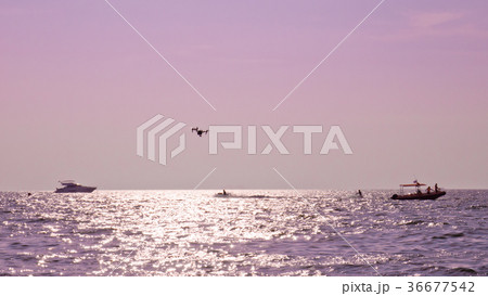 Professional camera drone flying on sea. Professional camera drone flying on sea. 36677542