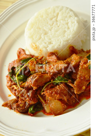 spicy stir fried grilled pork curry with herb  36677771