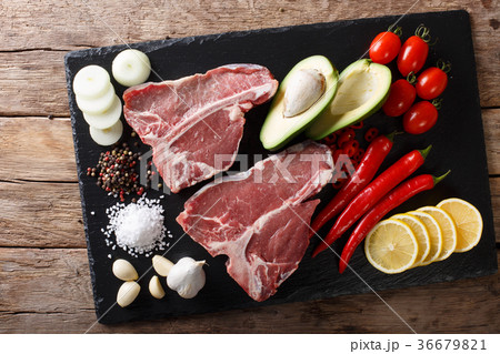 Organic raw t-bone beef steak with ingredients 36679821