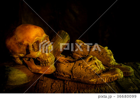 Still life with human skull and shoes on wooden Still life with human skull and shoes on wooden 36680099