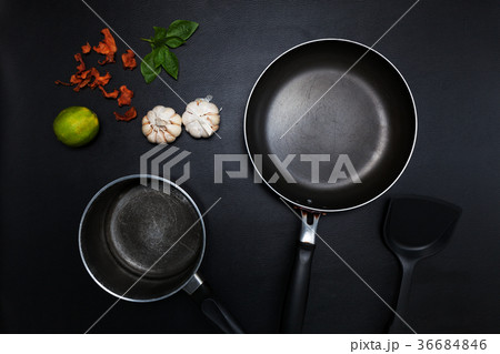Top view frying pan and pot on black table. Top view frying pan and pot on black table. 36684846