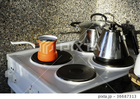 pot, kettle and coffee pot on the stove 36687313