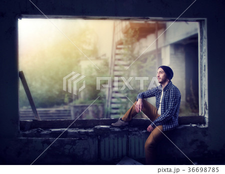 Stalker sitting on the window, abandoned city 36698785