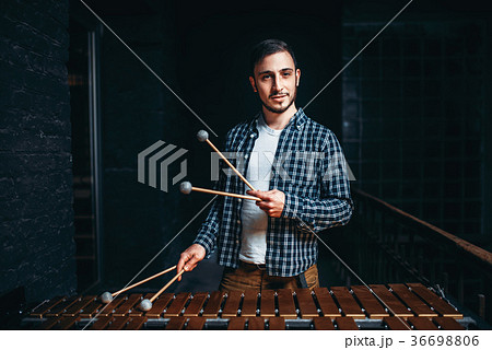 Young male xylophone player with sticks in hands 36698806