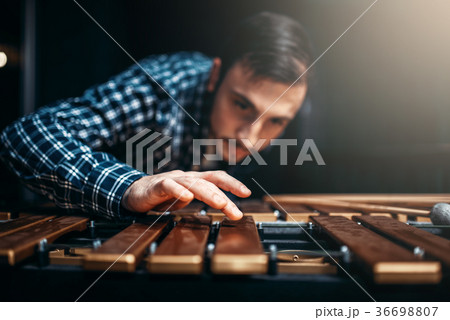 Xylophone player with sticks, musician in action 36698807