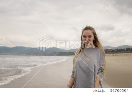 teen girl walking on Santa Monica beach in cloudy 36700504