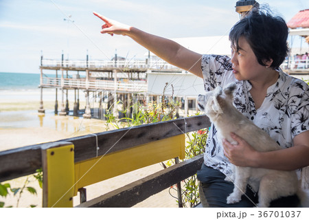 Asian women and dog at beach and sea when travel 36701037
