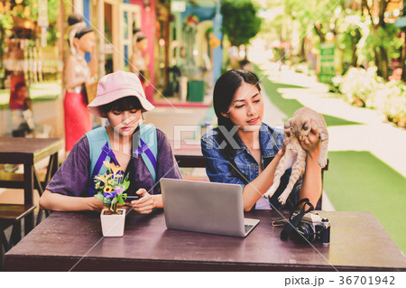 A tourist girl searching for accommodation on the internet and m 36701942