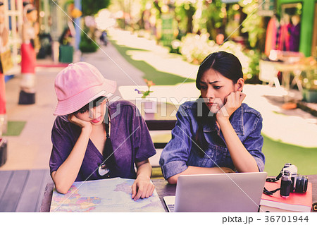 A tourist girl searching for accommodation on the internet and m 36701944