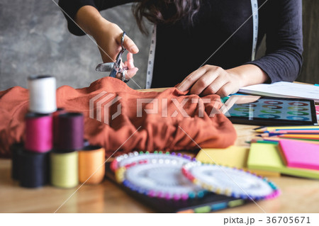 Young woman dressmaker or designer working as fashion designers Young woman dressmaker or designer working as fashion designers 36705671