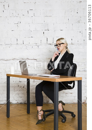 Young blond beauty businesswoman sitting at a 36706113
