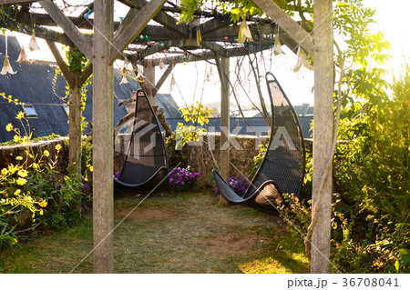 Wicker hanging chairs in the garden 36708041