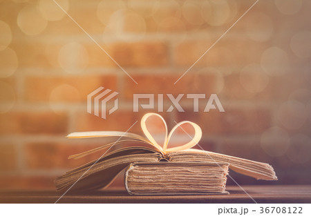 old books on wooden table at fairy lights  36708122