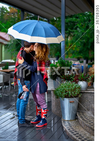 A young couple on the terrace hugs under an 36708365