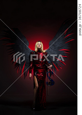 Female with big angel wings on black background. 36708724