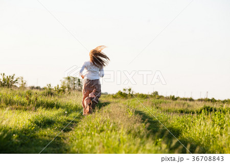 The girl ran across the field 36708843