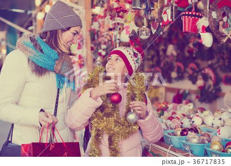smiling mother with little daughter buying decorations for Xmas 36717835