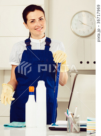 Young and smiling woman cleaning room Young and smiling woman cleaning room 36717969