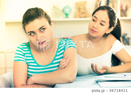 Girl trying to apologize to friend Girl trying to apologize to friend 36718421