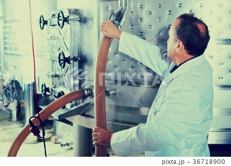Elderly man in uniform works with equipment Elderly man in uniform works with equipment 36718900