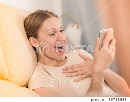 Laughing woman with phone 36718953