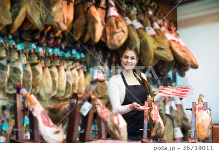 butcher with lard and meat in counter of store 36719011