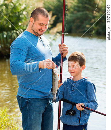 Portrait of father and son fishing with rods 36719149