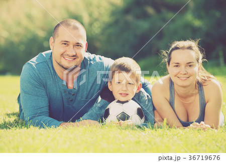 family lying in the grass. family lying in the grass. 36719676