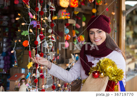 Girl choosing Christmas decoration Girl choosing Christmas decoration 36719770