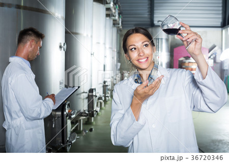 Portrait of happy woman looking at wine sample 36720346
