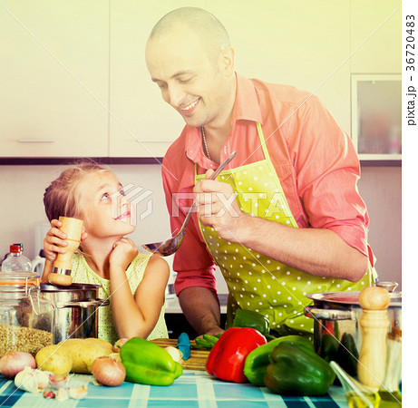 girl helping father to prepare dinner 36720483